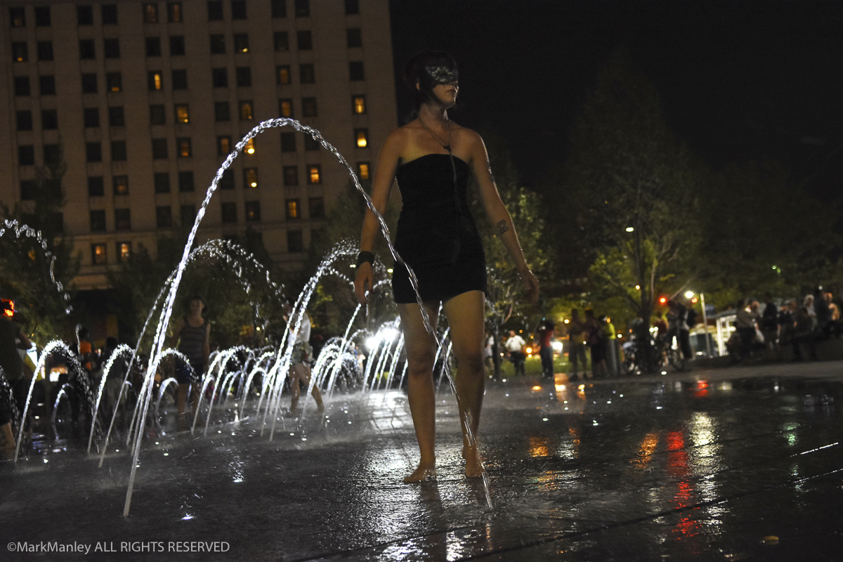 A young woman relaxes in a fountain at Public Square in Cleveland during the RNC.
