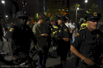 A Cleveland police bike patrol detains and checks the I.D. of a man near Settlers Landing during the RNC. Police presence  was large, with 2,800 additional officers brought in from around the country to supplement the Cleveland Department. Despite the large numbers, Cleveland Police reported only 24 total arrests related to the RNC.