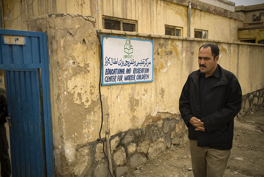 Hakim Ahmadyaar, stands outside the AWEC Center where he works as a Social Worker.