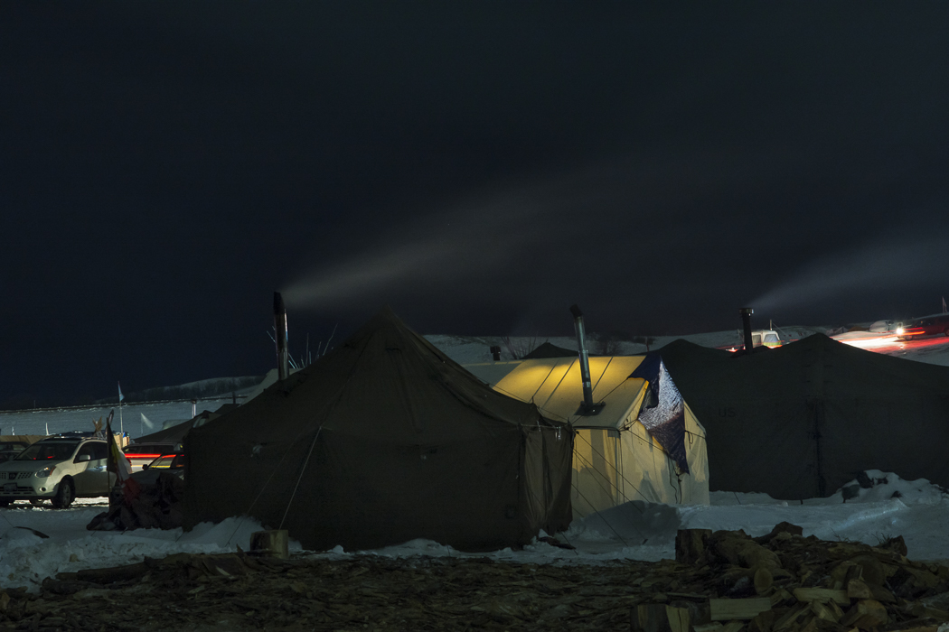 Army surplus tents were much sought after because they were better winterized and could accommodate wood stoves. There was a team of volunteers at camp building stoves from 50 gallon oil drums for distribution throughout the camp.