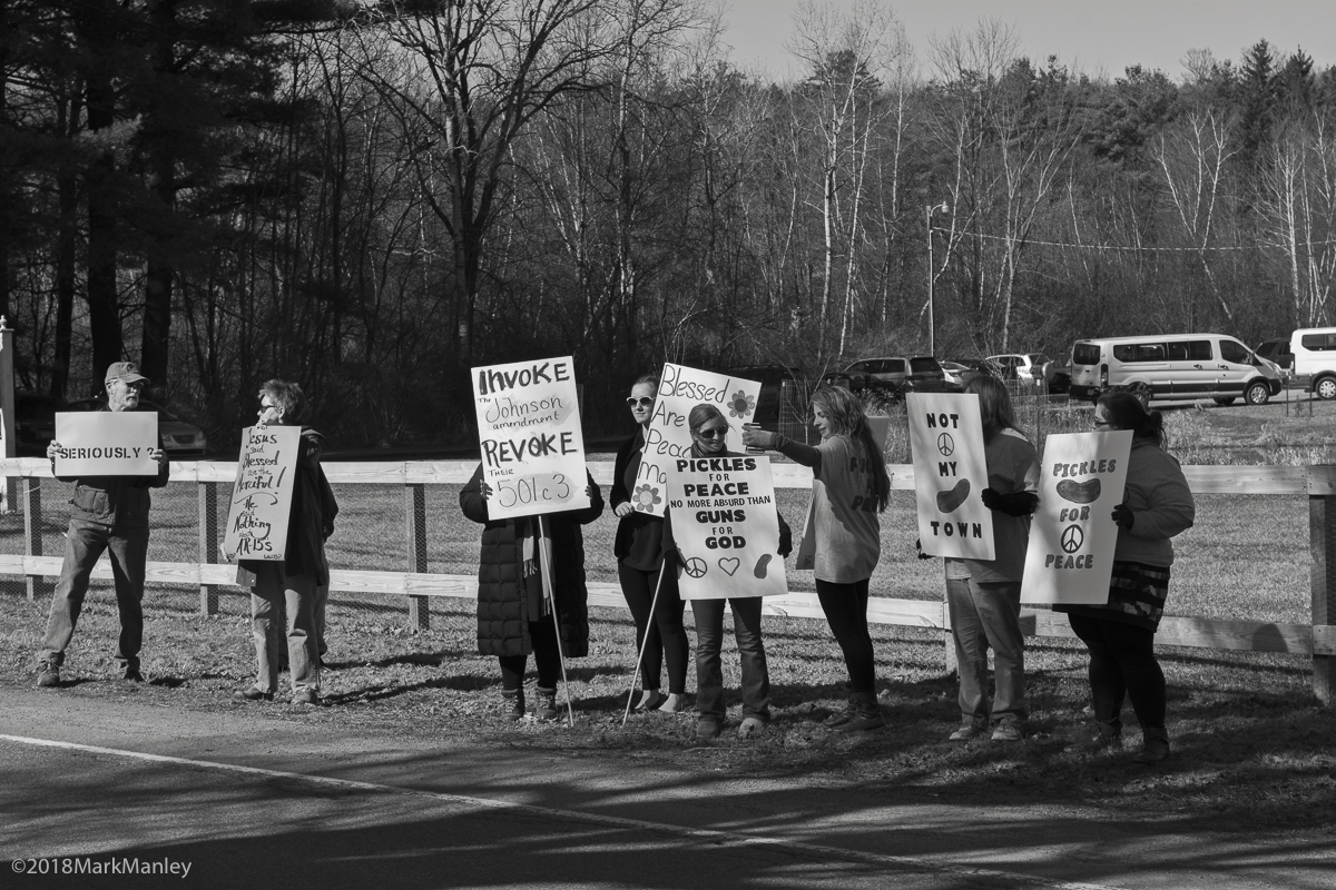 Outside the church a small group of local residents demonstrated.