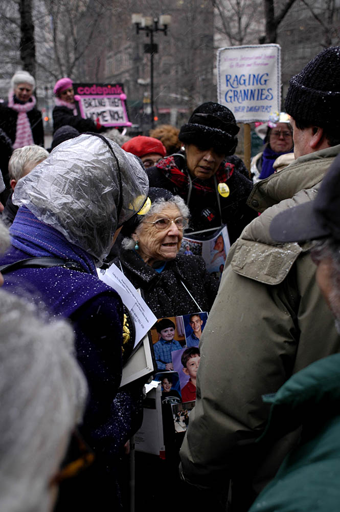 Molly Klopot, surrounded by grandmothers as they huddle together to receive final instructions from their attorney Norman Siegel prior to entering court. Eighteen grandmothers were arrested while trying to enlist at the military recruiting center in Times Square in October 2005.