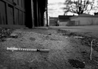 A discarded syringe is left in an alley behind a dilapidated apartment building on South Grand Boulevard in St. Louis on Thursday, Feb. 9, 2017. A year earlier, heroin user Eric Bearden, 28, died of a heroin overdose inside the apartment building. The alley is still known for it's drug use. 