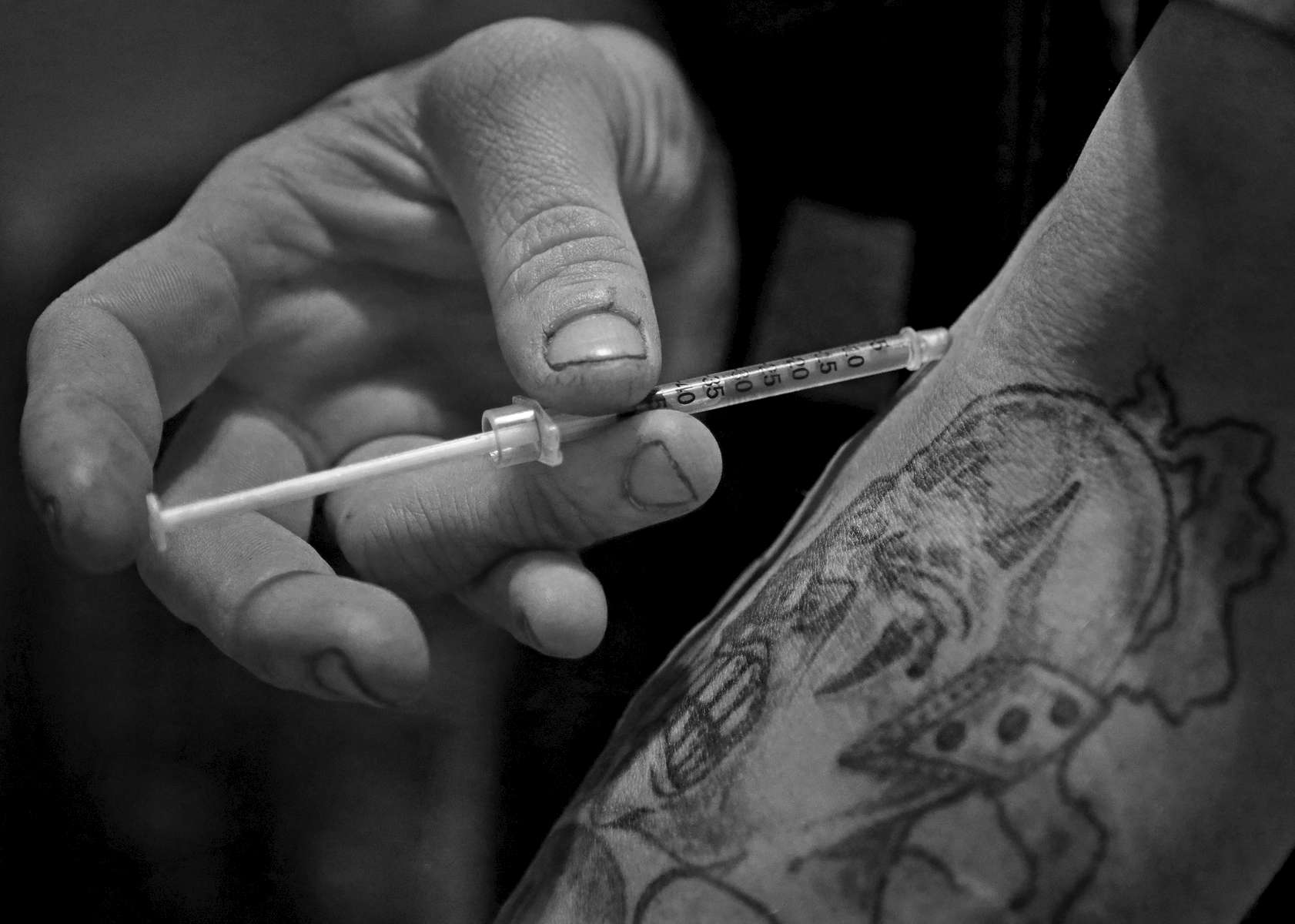 Richard Skinner shoots heroin on Monday, Feb. 6, 2017, into a vein near a tattoo he got during a stint in prison years earlier.  {quote}Heroin is the only thing that ever stole my soul. I'm not me any more{quote} says Skinner. Skinner who had to be revived by paramedics from a a near fatal overdose just a few weeks ago {quote}Death ain't nothing to me anymore{quote}  