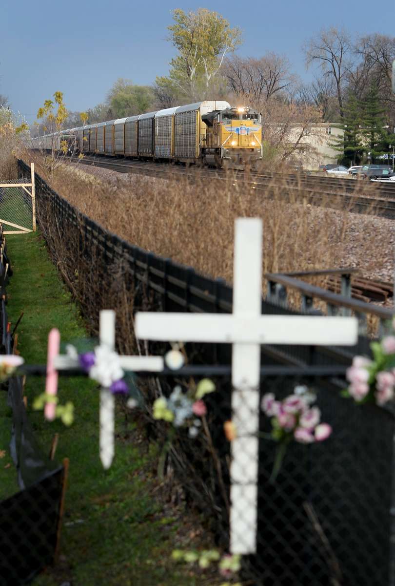 A freight train rolls along the tracks in Villa Park, Ill. on Saturday, Nov. 10, 2012 past a memorial for a middle school girl who was killed by a train in 1988.  Heather Hayes was 14 when she was struck and killed by a train while walking home from school.  Almost twenty year after Hayes' death community reaction to another train fatality involving a different 14 year-old, Kristen Bowen, helped get fences put up along the tracks near the middle school and a nearby park.Photo By David Carson, dcarson@post-dispatch.com