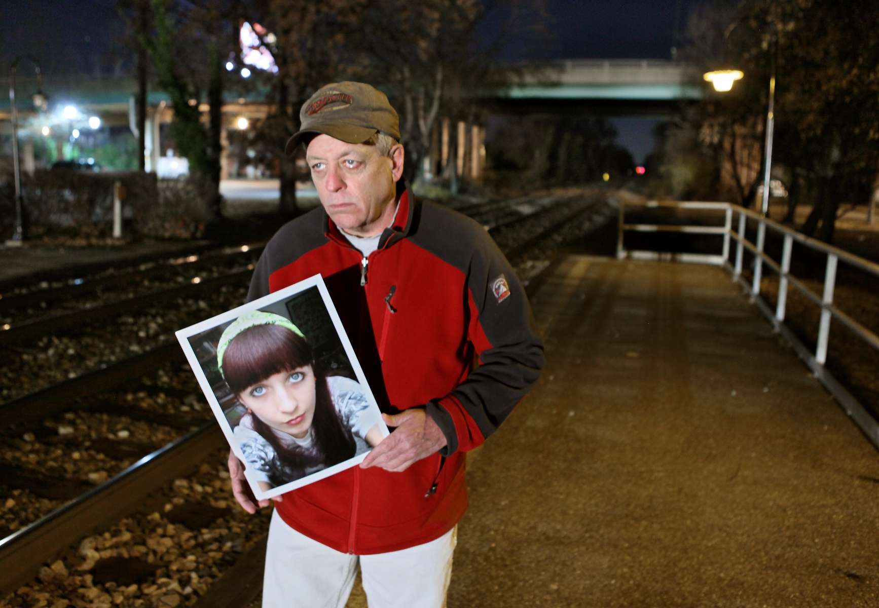 Walter Gaffney holds a picture of his 17-year-old daughter Mary Gaffney on Wednesday, Nov. 28, 2012, along the set of tracks where she was hit and killed by a train in Riverdale Park, Md..  Mary Gaffney and two other people were killed by trains the same day as 14-year-old Cam Vennard, from Kirkwood, was stuck and killed by a train.  Photo By David Carson, dcarson@post-dispatch.com