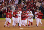 Carlos Beltran is mobbed by his teammates after connecting on the game inning hit in the 13th inning of Game 1 of the National League Championship Series between the St. Louis Cardinals and the Los Angels Dodgers on Friday, Oct. 11, 2013, at Busch Stadium in St. Louis. 