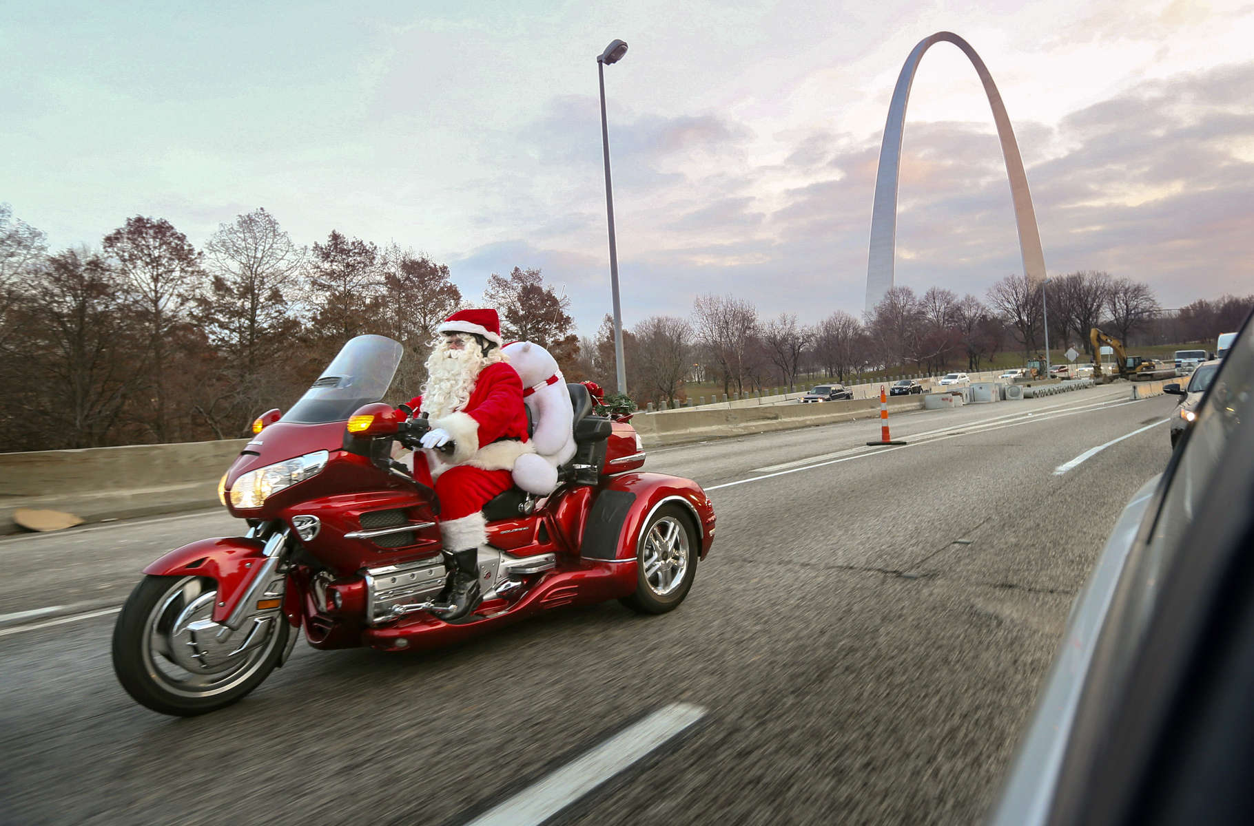 Danny Wall, from Fenton, cruises down Interstate 70 West through downtown St. Louis on his way to deliver a present to a three-year-old boy in Granite City on Tuesday, Dec. 3, 2013.  {quote}I love seeing the expression of joy on people's faces as I drive by{quote} said Wall who started playing the role of Santa Claus eight years ago when his first grandchildren were born.  At first he visited just the homes of friends and family but he has visited with groups Boy Scouts, Girl Scouts, and children at Rankin Jordan.  He says playing Santa Claus helps him get the Christmas spirit and relieve stress.  Wall is a riding a 2008 Honda Goldwing Trike.Photo By David Carson, dcarson@post-dispatch.com