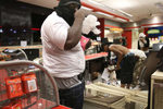 A looter armed with a gun takes items inside the QuikTrip in 9400 block of W. Florissant Avenue in Ferguson, Mo. on Sunday, Aug. 10, 2014.  Rioters set fire to the store about an hour later.