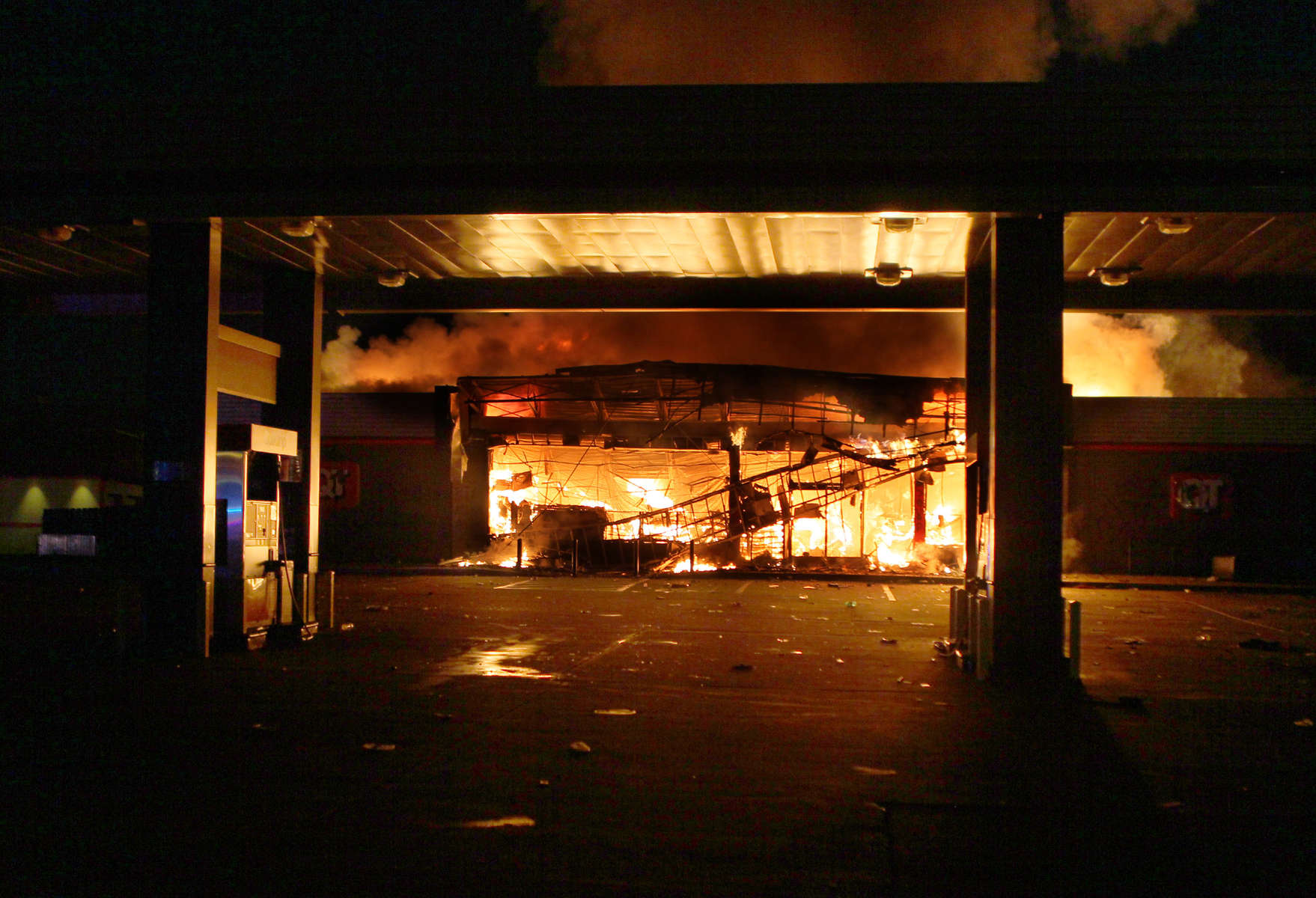 The QuikTrip in 9400 block of W. Florissant Avenue in Ferguson, Mo. burns after being looted by rioters on Sunday, Aug. 10, 2014.  The looting and riots began after a candlelight vigil for Michael Brown when confrontions between police and protesters spiraled out of control.