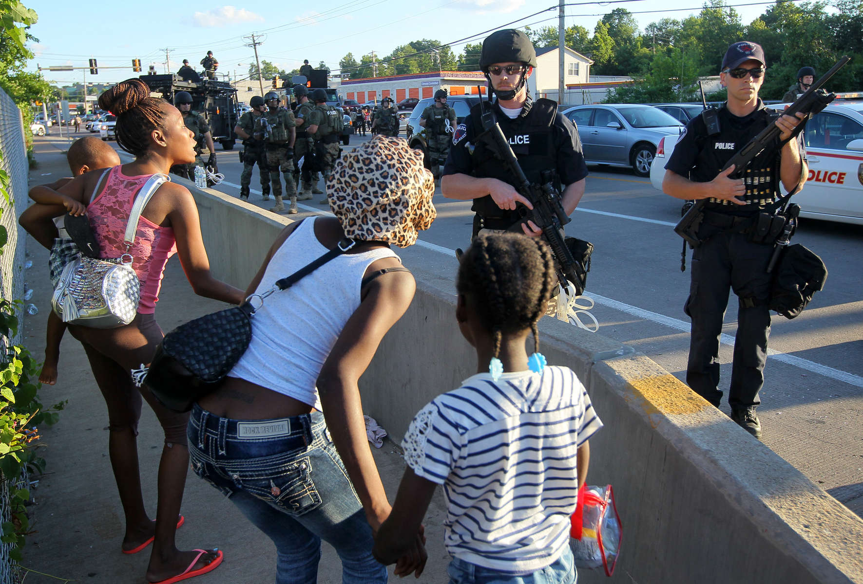 Women argue with police officers to let them pass and go home because they were afraid of being near the protest scene with their children if things turned violent along W. Florissant Avenue on Tuesday, Aug. 12, 2014.  The women were eventually allowed to pass, but not without a heated argument between them, the crowd and the police.Photo By David Carson, dcarson@post-dispatch.com