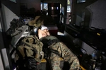 A member of the St. Louis County Police tactical team sleeps in the back of the team's armored truck after arriving back at the command post W. Florissant Avenue at about 2:49 A.M. on Tuesday, Aug. 19, 2014.  