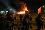 St. Louis County Police tactical team arrive on W. Florissant Avenue to disperse crowd as the Beauty Town store burns on Monday, Nov. 24, 2014. Photo By David Carson, dcarson@post-dispatch.com