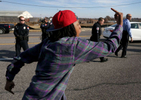 A protester balances along the curb while marching past a line of police flipping them off during a demonstration along Hanley Road on Saturday, Nov. 29, 2014.Photo By David Carson, dcarson@post-dispatch.com
