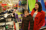Amelia Alonzo, 9, and her mother Tracy Alonzo look over an aisle where protesters were holding a 4.5 minute die in at the Target in St. Louis County off of South Lindbergh Boulevard on Sunday, Nov. 30, 2014.  {quote}We're explaining to her that people need their voices to be heard and that there is nothing scary going on here{quote} said Tracy Alonzo {quote}We support the protesters, I was was excited to see them here{quote}.  The protesters marched around the store and chanted for 20 minutes before leaving.  Other shoppers had a different reaction to the protests and were visibly shaken by what they saw and heard. Earlier the protesters also marched and chanted in the Walmart off of Telegraph Road. Both stores announced they were closing early and police ordered the protesters to leave, which they did. Photo By David Carson, dcarson@post-dispatch.com