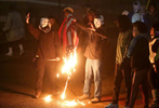 Protesters burn an American flag across the street from the Ferguson police department to taunt National Guard troops and police lined up outside the station on Thursday, Dec. 4. 2014.  After the flag burned protesters threw the flag on the ground and National Guard troops walked across the street and picked up the charred remnants of flag so they could properly dispose of it.Photo By David Carson, dcarson@post-dispatch.com
