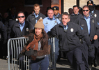A protester runs away from police after she pushed a metal barricade in their direction outside the St. Louis Police Headquarters on Wednesday, Dec. 31, 2014.  She was arrested a short time later.Photo By David Carson, dcarson@post-dispatch.com