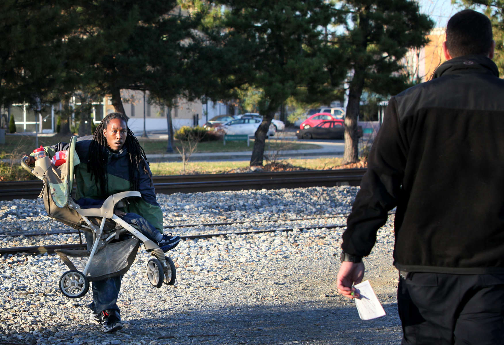 A man carrying a baby stroller across a set of train tracks in Hyattsville, Md., is stopped by CXS railroad police on Thursday, Nov. 29, 2012.  Even though the officer was only in the area performing surveillance of the tracks on an unrelated investigation he said he feels compelled to stop people who are trespassing when he sees it.  The man with the stroller, who did not want to be identified, was given a warning by the police.  Two fatalities have occurred in the area where the man crossed the tracks.  There are several no trespassing signs posted along either side of the tracks.Photo By David Carson, dcarson@post-dispatch.com