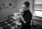 Camden, 4 months, is snuggled by his mother Amanda Davis in their private room at a Queen of Peace Center maternity home in the College Hill neighborhood of St. Louis on Thursday, Feb. 23, 2017. Davis, a recovering heroin addict, entered the Queen of Peace program to help her kick her heroin addiction when she found out she was pregnant with Camden. She is taking weekly drug tests now to prove that she is clean and will soon be moving into her own apartment. Her hope is after proving she is clean and moving into her own apartment she'll be able to regain custody of her other children that were taken away by the state when she was using drugs.
