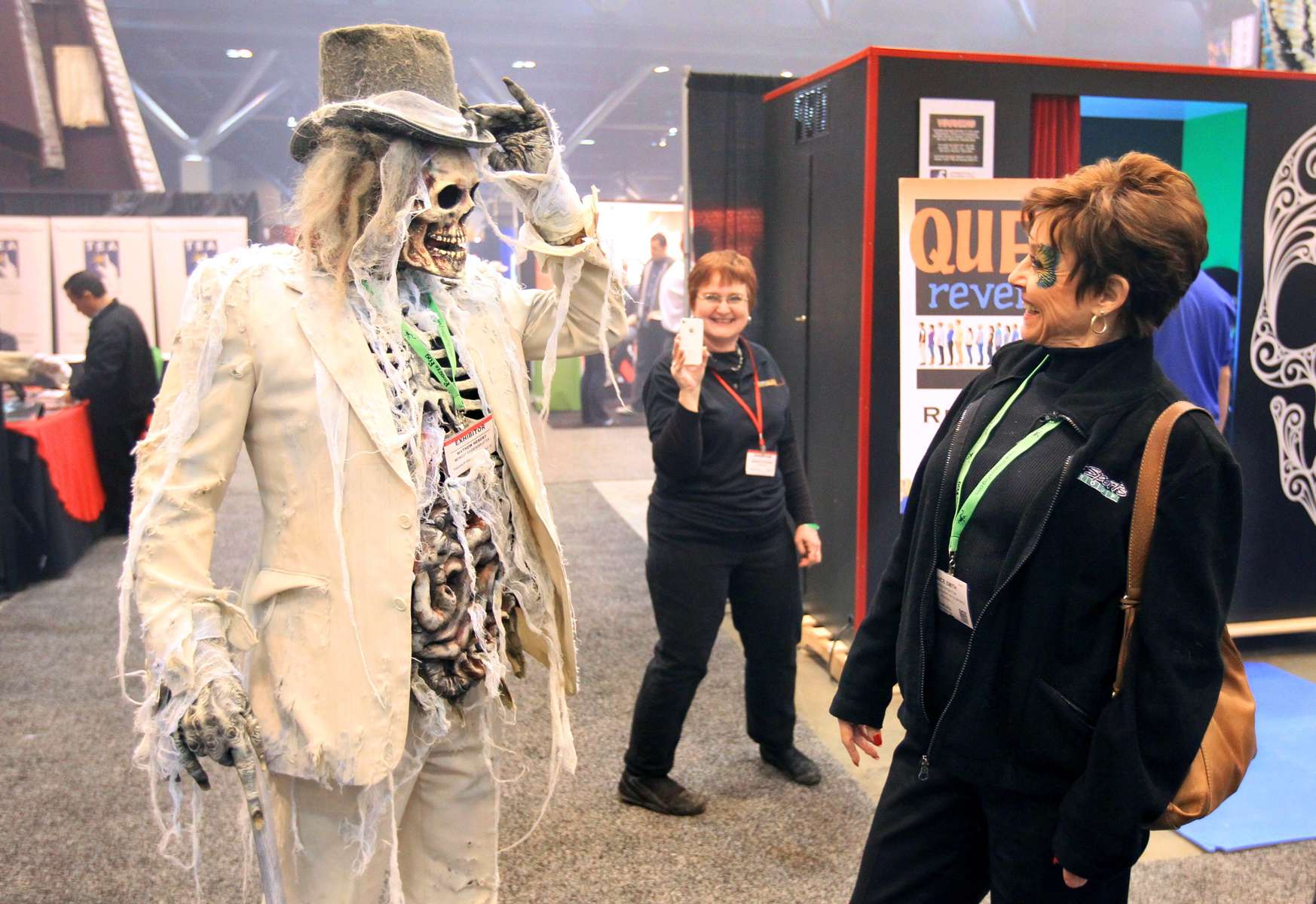 Mathew Hebert (left), from Midnight Studios out of Mesa, Arizona, stops to talk with Janice Smith, from Ballwin, as he walks the floor of the 17th annual Halloween and Attractions Show at America's Center in St. Louis.