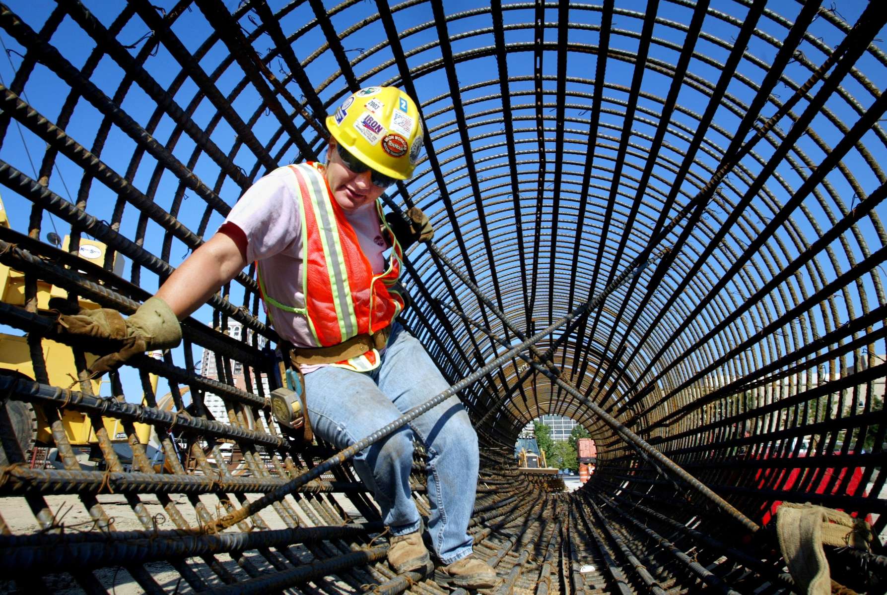Friday July 25, 2003--Local 396 Iron Worker Crystal Farris, of Bourbon, Mo., climbs out of a rebar cage that will be sunk into the ground and filled with concrete to create the foundation for a bridge in the MetroLink expansion project on Forest Park Parkway.Photo By David Carson/PD