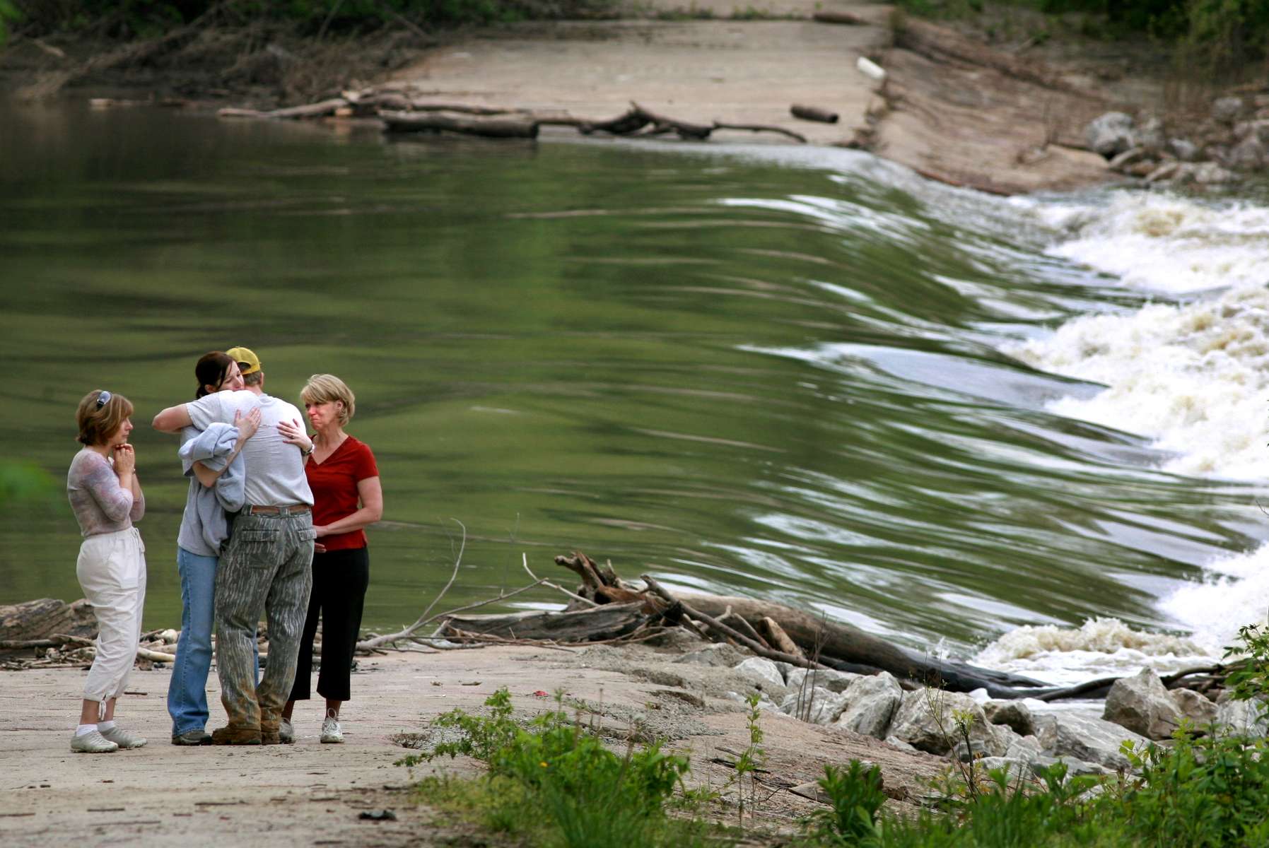 Tuesday May 6, 2008--Friends and family members of 27-year-old Keith R. Fietsam of Winfield, Mo. console each other down by the side of the Missouri River after rescuers called off a four and a half hour search for Fietsam around 11:30 AM on Tuesday.  Fietsam and a friend were crossing the Centaur Chute of the Missouri River when their canoe capsized as they were attempting to cross over to the Howell Island Conservation area to hunt turkeys.  The strong current on river surprised the hunters as it sucked the boat into turbulant water, pictured to the right. Fietsam's hunting partner Leo Geringer clung to the boat and was able to make it to shore.  Rescue workers presume Fietsam is dead.  Divers will resume efforts to find Fietsam's body on Wednesay morning. David Carson | Post-Dispatch