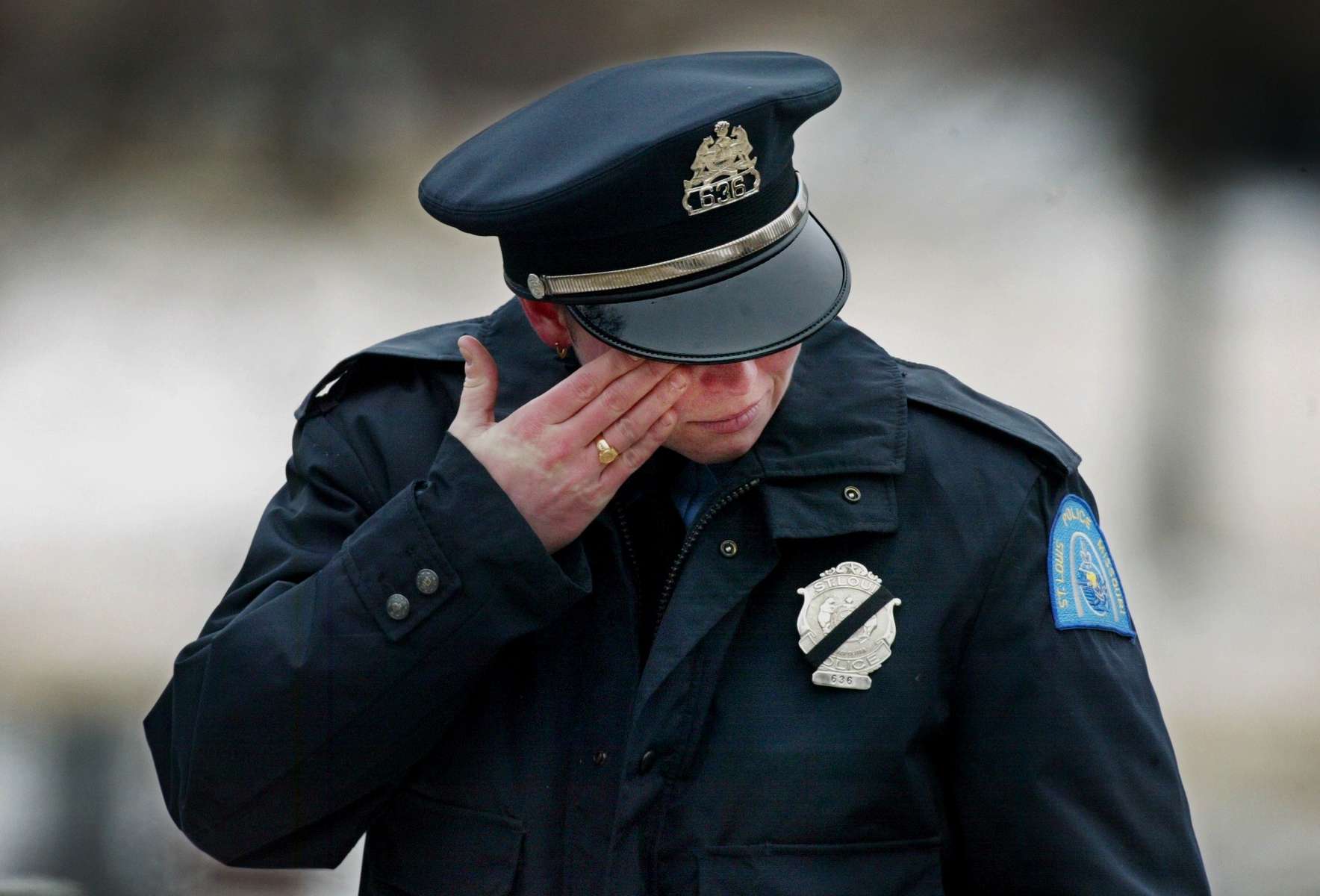 Wednesday February 4, 2004--St. Louis Police officer XXXXXX Fischer wipes tears from her eyes after fellow officer Nicholas Sloan was laid to rest at Calvary Cemetery on Wednesday.Photo By David Carson/PD  (We are working on Getting officer Fischer's first name at this time)