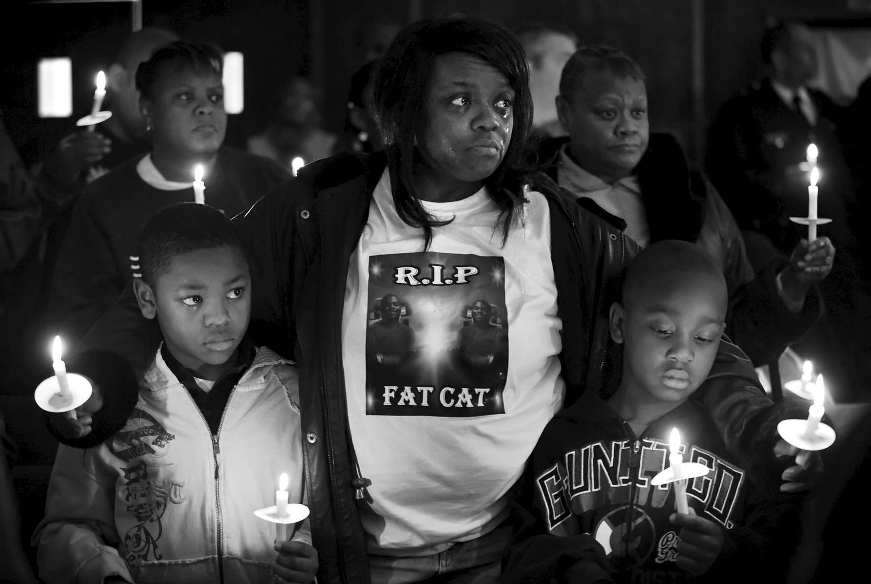 Thursday December 31, 2009--Byron Blassingame Jr., left, and Darrion Bassingame Jr., right, are comforted by their grandmother Jacqueline Heard, center, as the names of the 145 murder victims from the city of St. Louis are read aloud during the 18th Annual Families Advocating Safe Streets candle light service to remember 2009's murder victims at El Bethel Church of God in Christ on Thursday in St. Louis.  Heard's son Byron Blassingame Sr. was shot and killed along with two other men in the same SUV as they were waiting at stop light near Union Station on May 8, 2009.  Byron Jr. was Byron Blassingame Sr.'s son and Darrion Blassingame Jr. was his nephew.David Carson     dcarson@post-dispatch.com