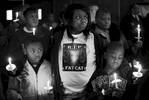 Thursday December 31, 2009--Byron Blassingame Jr., left, and Darrion Bassingame Jr., right, are comforted by their grandmother Jacqueline Heard, center, as the names of the 145 murder victims from the city of St. Louis are read aloud during the 18th Annual Families Advocating Safe Streets candle light service to remember 2009's murder victims at El Bethel Church of God in Christ on Thursday in St. Louis.  Heard's son Byron Blassingame Sr. was shot and killed along with two other men in the same SUV as they were waiting at stop light near Union Station on May 8, 2009.  Byron Jr. was Byron Blassingame Sr.'s son and Darrion Blassingame Jr. was his nephew.David Carson     dcarson@post-dispatch.com