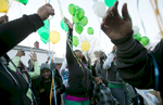 Shenelle Burgess (center) releases balloons with her family and friends at the grave of her son Pierre Childs at New Bethlehem Cemetery on Wednesday, March 5, 2014.  Police believe that Childs,16, was the unintended victim of a shooting on May, 7, 2013.  The family of Childs has been helped through the grieving and police investigation process by a minister assigned to the family by the police department.  The family gathered to release balloons to mark what would have been Childs' 17th birthday.  To date no one has been charged with Childs' murder.Photo By David Carson, dcarson@post-dispatch.com