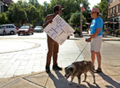 Dhoruba Shakur (left), and Anna Forder have a discussion at the intersection of Euclid Avenue and Maryland Avenue close to where a St. Louis police sergeant was shot on Tuesday, July 14, 2015. Shakur, a community activists and regular protester, was standing at the intersection with a sign that read {quote}How does it feel??{quote} when Forder approached him and the pair began talking. Forder, a retired St. Louis judge, told Shakur she felt the sign was {quote}taunting{quote}.  Shakir said he was holding the sign {quote}So people feel disrespected the way I feel disrespected every day{quote}. Shakur feels that the United States was founded on white supremacy and that it still impacts his life. The pair talked calmly for more than 5 minutes debating issues of race and violence. The conversation ended politely and they parted with an exchange of smiles.{quote}He's a smart young man. He's educated. But I'm very upset about the shooting of the police officer{quote} said Forder who felt the conversation had been positive. Shakur felt differently about the conversation {quote}She was being condescending{quote}.Photo By David Carson, dcarson@post-dispatch.com