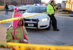 Destiny Mims, 6, watches as police work the scene of a fatal shooting on North 8th Street in St. Louis on Wednesday, Jan. 13, 2016. Mims ,who lives a block away from where the shooting happened, was walking home from school with her mother and brother when they stopped to view the scene. As police were investigating the shooting on North 8th Street more gun shots were heard in the distance, to the east near Interstate 70.Photo by David Carson, dcarson@post-dispatch.com