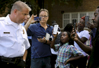 J'volte Jones, 8, holds up a cellphone to record video of St. Louis police chief Sam Dotson (left) as Dotson takes questions from the community after briefing the press about an incident where two St. Louis police officers shoot a 14 year-old boy in the 5000 block of Beacon Avenue in St. Louis on Sunday, Oct. 2, 2016. {quote}This shouldn't be their normal{quote} said J'vonte's mother Crystal Brown (not pictured). Dotson says the 14 year-old fired one shot at police who were chasing him, the police returned fire an unknown number of times hitting the boy.Photo by David Carson, dcarson@post-dispatch.com