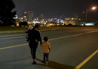 Donna Green and her sons Chris Allen (right), 3, and Donovan Allen, 2, crosses Chouteau Avenue shortly before 5 a.m. in the morning as they head to the bus stop on Monday, Aug. 14, 2017. Green works at a McDonalds in north St. Louis County and needs to leave her home in St. Louis City before 5 a.m. to catch two buses to drop her children at daycare. She then takes another bus to work.Photo by David Carson, dcarson@post-dispatch.com