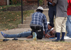 A woman leans in to talk with her nephew who was shot in the 1800 block of O'Fallon Street in St. Louis on Friday, Oct. 6, 2017. Two 20-year-old men on foot were shot by a suspect driving a silver Nissan Altima at about 2:40 p.m. Both men were transported to the hospital. One was shot twice in the upper torso and is in critical condition and the other was shot in the leg and is in stable condition.  Photo by David Carson, dcarson@post-dispatch.com