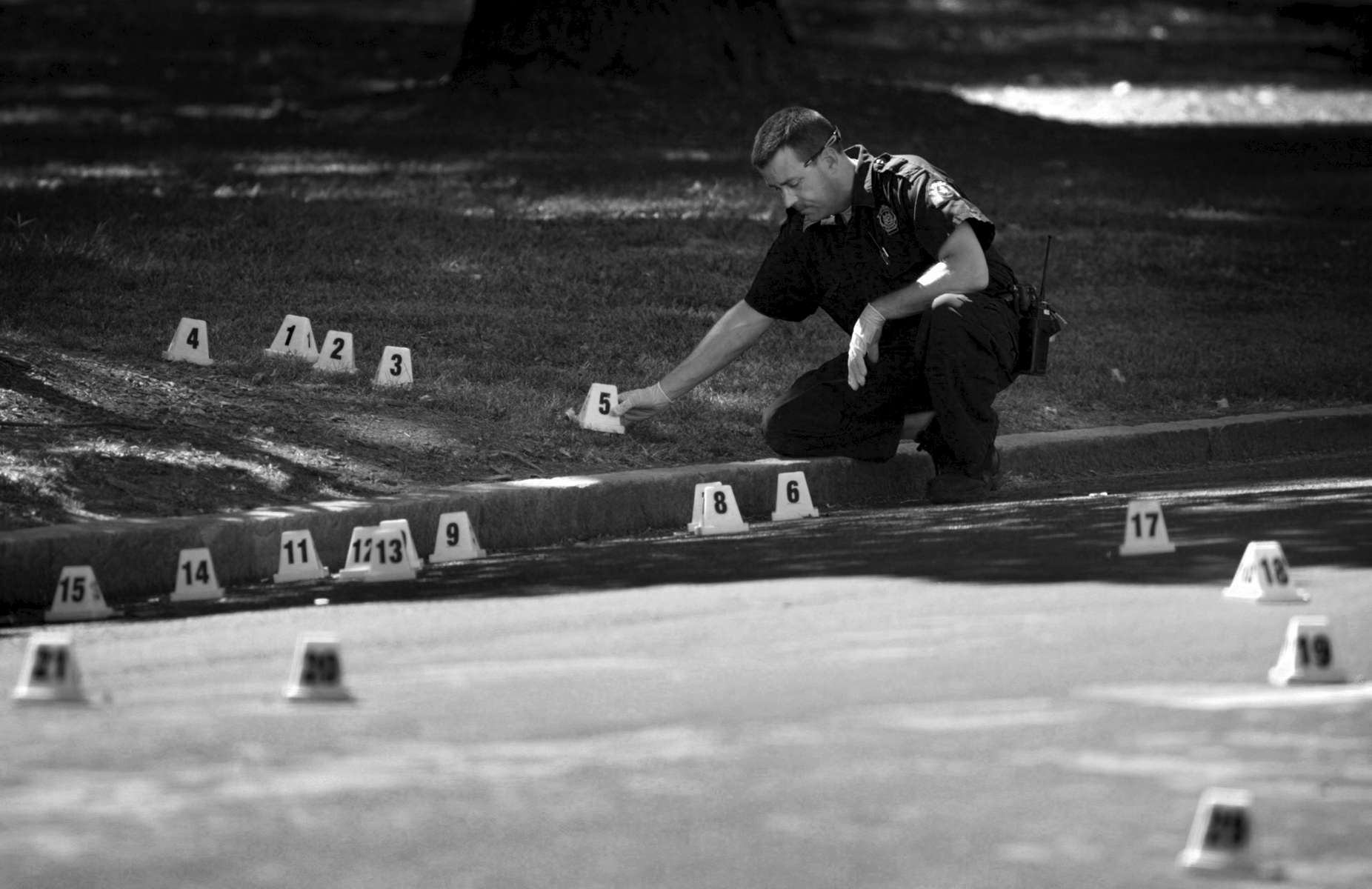 Thursday September 17, 2009--St. Louis Police Department crime scene technician Tom Burgoon places evidence markers next to all the shell casings that littered the ground near the scene of shooting at Fountain Ave. and N. Eucid Ave on Thursday.  The victim was transported to the hospital where he was listed in critical condition.David Carson     dcarson@post-dispatch.com