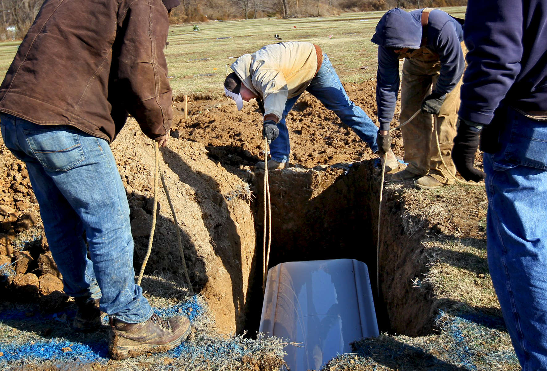 Tuesday March 1, 2011--Grave digger Adam Osborne, 24, center, and other workers from Lake Charles Park Cemetery lower 16 year-old Jade Hamilton's coffin into her grave after her funeral.  Hamilton had been sitting in a car at Mount Pleasant Park when three young men approached the car and began shooting, striking her in the neck, police said.  David Carson     dcarson@post-dispatch.com