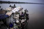 BOKONDO, DEMOCRATIC REPUBLIC OF CONGO APRIL 6: Unidentified people on a boat with destination Kinshasa on April 6, 2006 in Bokondo, Congo, DRC. Passengers sleep in the open, often on top of maize bags or other cargo. The boat carries many animals such as pigs, goats, crocodiles, monkeys, lizards, etc. The Congo River is a lifeline for millions of people, who depend on it for transport and trade. The journey from Kisangani to Kinshasa is about 1750 kilometers, and it takes from 3-7 weeks on the river, depending on the boat. During the Mobuto era, big boats run by the state company ONATRA dominated the traffic on the river. These boats had cabins and restaurants etc. All the boats are now private and are mainly barges that transport goods. The crews sell tickets to passengers who travel in very bad conditions, mixing passengers with animals, goods and only about two toilets for five hundred passengers. The conditions on the boats often resemble conditions in a refugee camp. Congo is planning to hold general elections by July 2006, the first democratic elections in forty years.(Photo by Per-Anders Pettersson)
