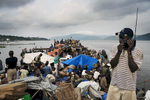MALUKU, DEMOCRATIC REPUBLIC OF CONGO APRIL 26: Unidentified passengers wait to disembark from a boat after traveling for seven weeks on April 26, 2006 in the port in Maluku, outside Kinshasa, Congo, DRC. About five hundred passengers traveled on the boat from Kisangani to Kinshasa, a distance of 1750 kilometers. These passengers spent seven weeks on a crowded boat with only two toilets and had to sleep among cargo, and share space with live animals such as pigs, goats, crocodiles, birds, lizards, snakes etc, The Congo River is a lifeline for millions of people, who depend on it for transport and trade. During the Mobuto era, big boats run by the state company ONATRA dominated the traffic on the river. These boats had cabins and restaurants etc. All the boats are now private and are mainly barges that transport goods. The crews sell tickets to passengers who travel in very bad conditions. The conditions on the boats often resemble conditions in a refugee camp. Congo is planning to hold general elections by July 2006, the first democratic elections in forty years. (Photo by Per-Anders Pettersson)