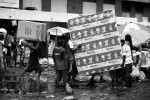 Angolan workers carry a mattress with a “Beijing 2008” sign in the Chinese market, Luanda, Angola, 2007
