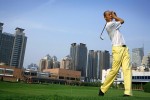 Zhang Yi, age 44, a director for an insurance company with 200 employees, plays golf at the Xian Country Club, Xian, China, 2007