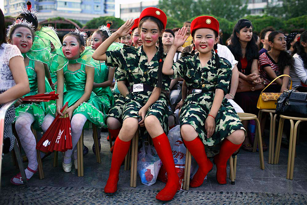 School children wait to perform during a talent competition, Kurle, China, 2007