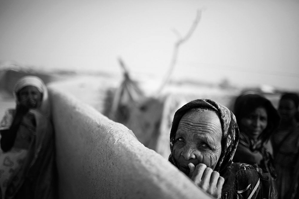 Women in the Oure Cassoni refugee camp close the border of Darfur, about 23 kilometers outside Bahai, Chad, 2007.  About 27,000 people live in grim conditions after fleeing the violence in nearby Darfur.