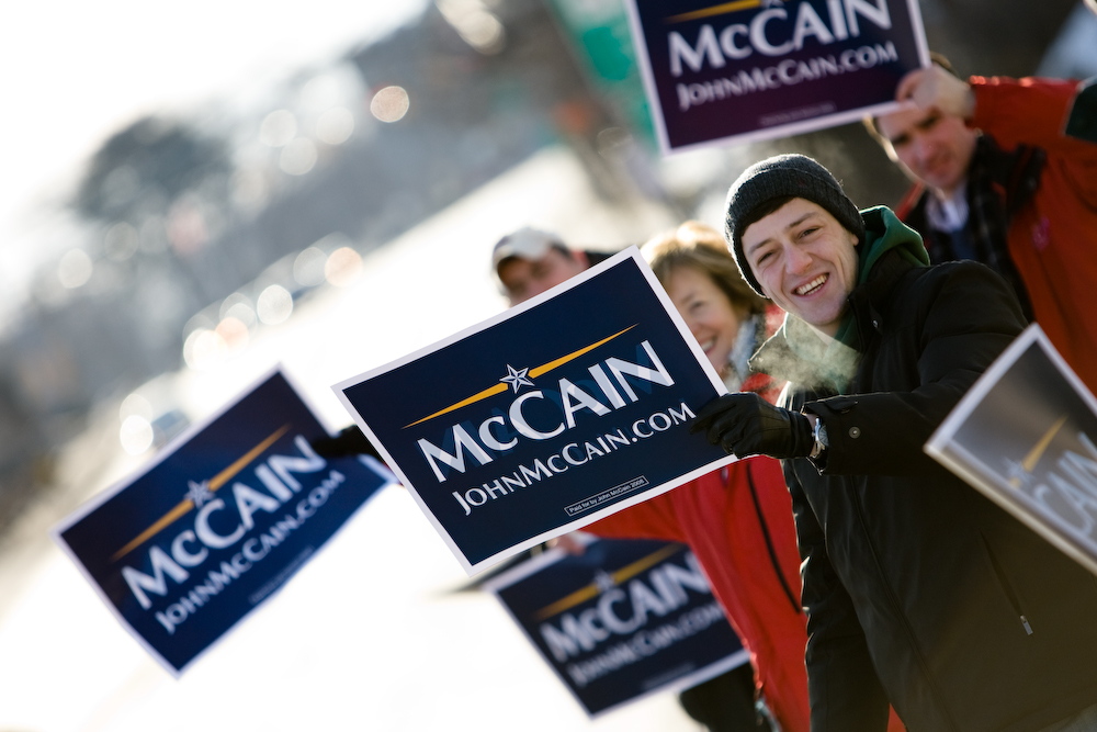 A college student braves the cold and holds a sign in support of presidential candidate Sen. John McCain (R-AZ).