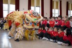 Students at Sacred Heart School watch a lion dance performance as part of Chinese New Year festivities.