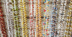 Papillion  JEWLERY RECYCLEDThe artisans of Papillion Enterprises, HAITI, use almost any kind of paper: magazines, scrap paper, and cereal boxes to craft their jewelry. These are cut into thin strips then carefully rolled on bamboo skewers to form beads.  After creating the beads, the artisan will mix them with seed beads, glass beads, and other native beads to make beautiful and unique necklaces, bracelets and earrings.