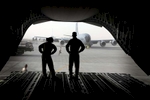 Loadmasters Senior Airman Christine Condoleon, left, and Master Sergeant Brian Cook, right,  stand on the loading ramp of their C17 cargo jet as they prepare to unload at an air base at an undisclosed location in the Persian Gulfon Saturday, February 23, 2009.  (Laurence Kesterson / Staff Photographer)  EDITORS NOTE:  JSUPPLY29, 2/21/09, McGuire AFB, New Jersey.  A supply mission to Afghanistan and other points in the Persian Gulf.  