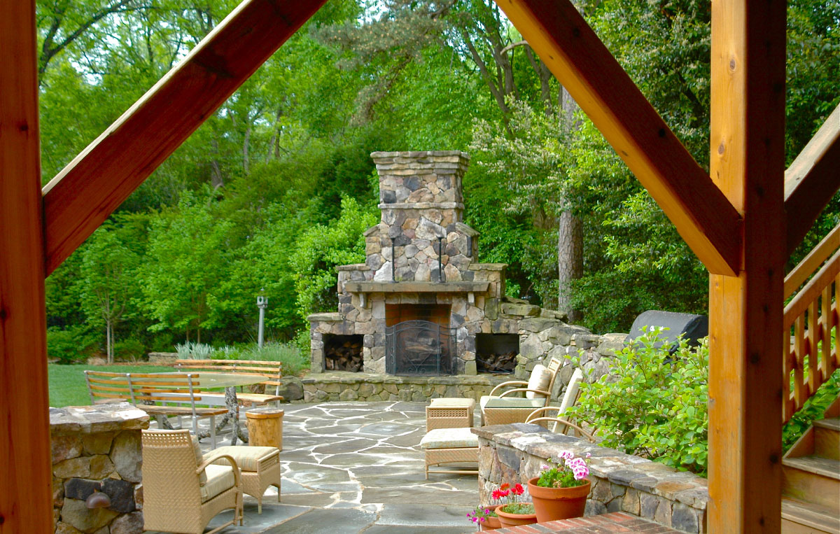 You can also turn right and step down towards the grand focal point on the Tennesee fieldstone patio -- a 13 foot tall custom fireplace with a rough-sawn cedar mantel.Richly stained cedar forms the stairway and railings that wrap a larger deck onto a transitional brick landing. Turn left and on your way to the parking area you'll walk by a splash of ferns, fatsia and hosta nestled beneath the new deck.