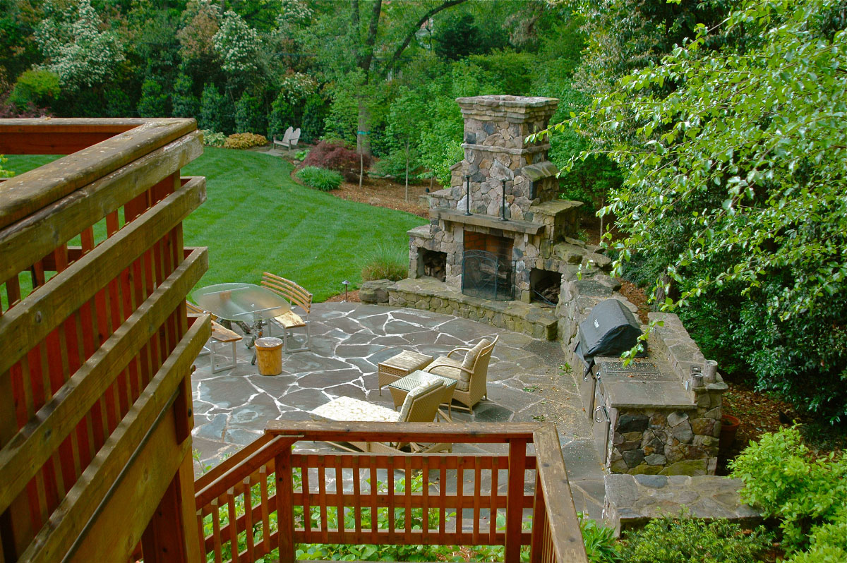 Phase two of this project began after the homeowners' deliberating for several years over desired function for their backyard. Our design allowed for more parking behind the house, which the homeowner wanted, and this area now leads down to a custom-designed upper deck  that spills int a ground level patio. This unified the space and the lawn  manages stormwater completely transforming the utility and use of the backyard environment. 