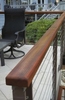 This detail view of the railing and Mahogany rail cap show the warm complimentary feel of the patio as it melds into the woodland landscape.